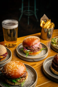 various burgers and pints