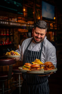 chef serving burgers to customers